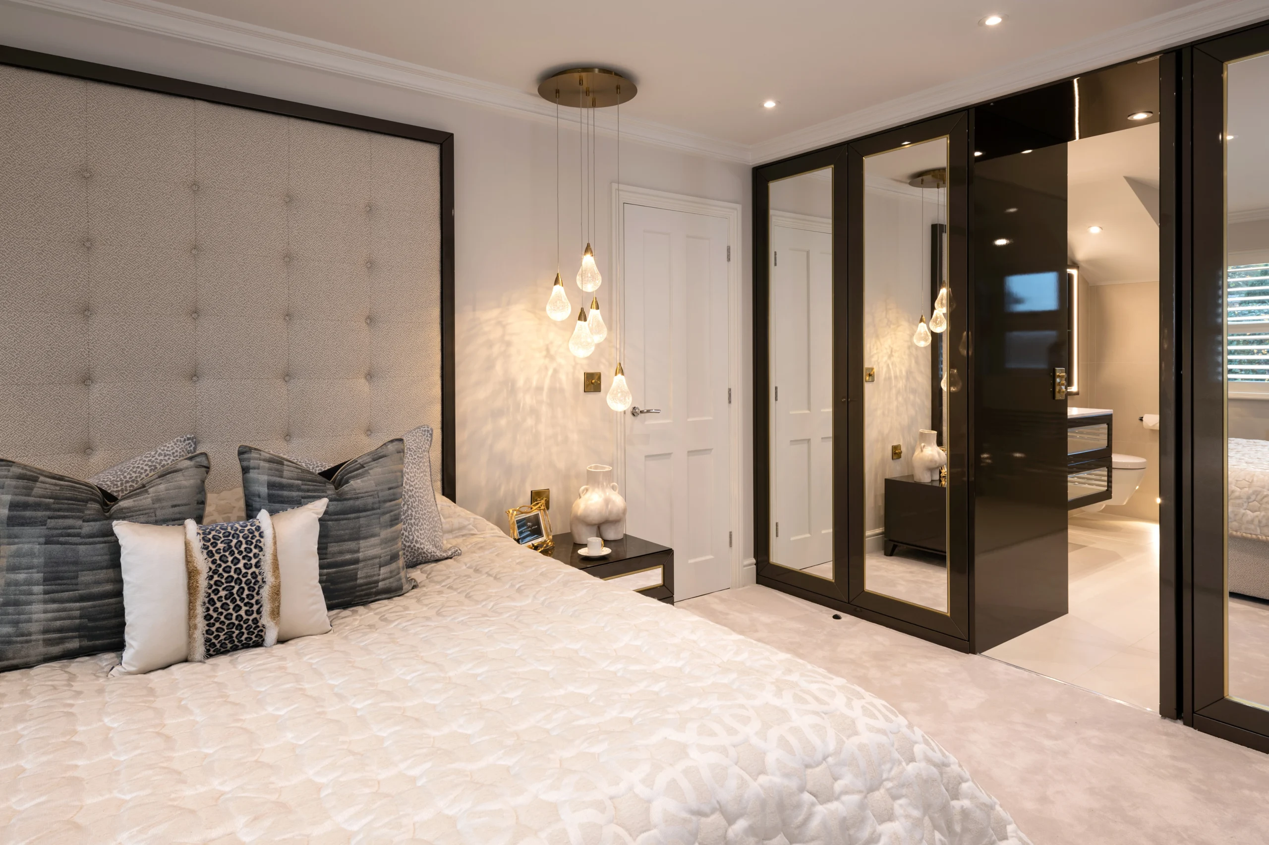 Full height headboard and hidden door in closet to ensuite
